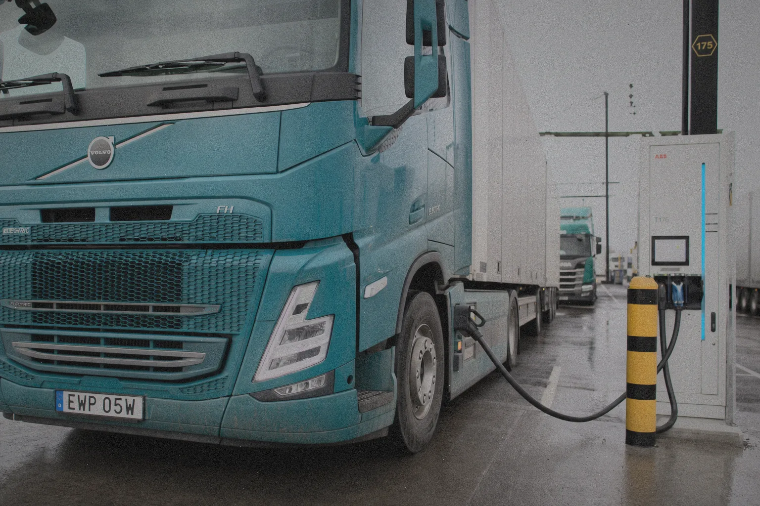 Elektryczna ciężarówka ładowana na stacji szybkiego ładowania w bazie transportowej